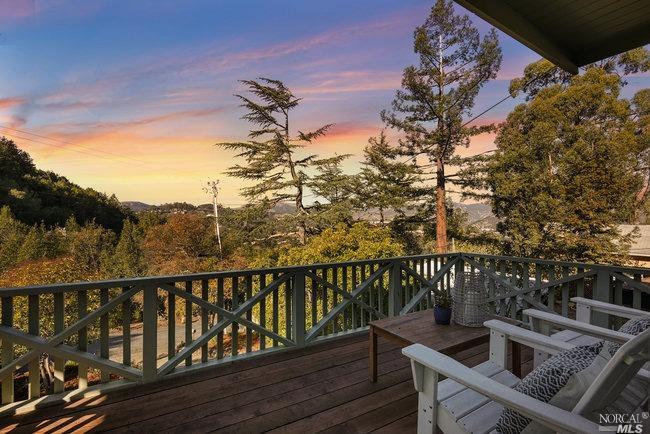 deck with forest and sunset views